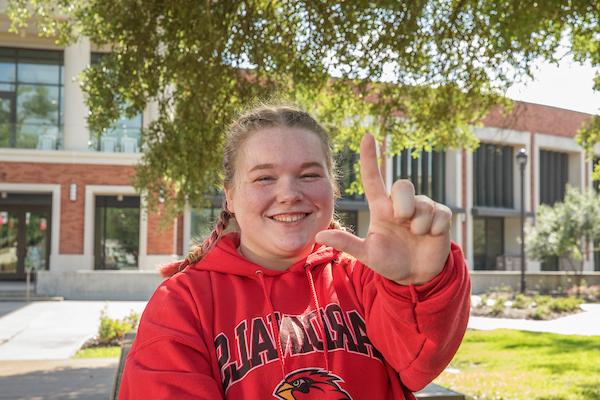 LU student holding hand in an L shape